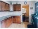 Functional kitchen featuring wooden cabinets, granite countertops, and view into the dining room at 5622 Nokomis Cir, Orlando, FL 32839