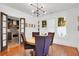 Inviting dining room with hardwood floors, modern lighting, and charming french doors leading to the kitchen at 647 E Livingston St, Orlando, FL 32803