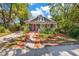 Beautifully landscaped front yard leads to this charming home with a welcoming red front door at 647 E Livingston St, Orlando, FL 32803