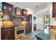 Functional kitchen boasting a stainless steel range hood, stone backsplash, and plenty of cabinet space for storage at 647 E Livingston St, Orlando, FL 32803