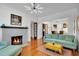 Cozy living room with hardwood floors, a decorative fireplace, and plenty of natural light at 647 E Livingston St, Orlando, FL 32803