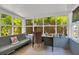 Cozy sunroom with natural light, a sofa, and a writing desk at 647 E Livingston St, Orlando, FL 32803