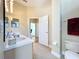 Bathroom featuring a double sink vanity and an open doorway to the carpeted bedroom at 712 Timberwilde Ave, Winter Springs, FL 32708