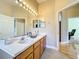 Bathroom vanity featuring a double sink and doorway leading to another room at 712 Timberwilde Ave, Winter Springs, FL 32708