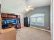 Neutral bedroom with a large window, a ceiling fan, and built-in wooden shelves and cabinets at 712 Timberwilde Ave, Winter Springs, FL 32708