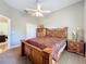 Bedroom with a bed, ceiling fan, and wooden armoire and nightstand for storage at 712 Timberwilde Ave, Winter Springs, FL 32708