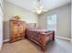 Bedroom with a bed, ceiling fan, window for natural light, and wooden furniture at 712 Timberwilde Ave, Winter Springs, FL 32708