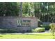 A brick community welcome sign for Winding Hollow neighborhood surrounded by meticulously maintained, lush landscaping at 712 Timberwilde Ave, Winter Springs, FL 32708