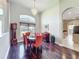 Dining area with hardwood floors, chandelier, and a large window providing natural light at 712 Timberwilde Ave, Winter Springs, FL 32708