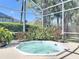 Relaxing outdoor hot tub surrounded by lush landscaping and a screened enclosure at 712 Timberwilde Ave, Winter Springs, FL 32708