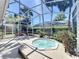 Backyard hot tub is surrounded by lush landscaping within a screened patio, creating a relaxing outdoor space at 712 Timberwilde Ave, Winter Springs, FL 32708