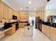 Spacious kitchen featuring an island, granite countertops, stainless steel appliances, and tile flooring at 712 Timberwilde Ave, Winter Springs, FL 32708