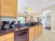 Spacious kitchen featuring wood cabinets, black countertops, updated appliances and lots of natural light at 712 Timberwilde Ave, Winter Springs, FL 32708