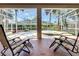 Screened lanai featuring tile flooring, chairs, and view of hot tub and landscaping at 712 Timberwilde Ave, Winter Springs, FL 32708