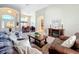 Cozy living room with plush leather seating, fireplace, and views into the dining area at 712 Timberwilde Ave, Winter Springs, FL 32708