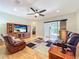 Spacious living room featuring a ceiling fan, hardwood floors, and leather furniture at 712 Timberwilde Ave, Winter Springs, FL 32708