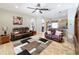 Inviting living room featuring hardwood floors, a ceiling fan, and comfortable leather couches at 712 Timberwilde Ave, Winter Springs, FL 32708