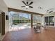 Spacious screened patio with ceiling fans, tiled flooring and views of the landscaped backyard and hot tub at 712 Timberwilde Ave, Winter Springs, FL 32708