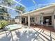 Screened patio with hot tub, tiled floor, and an inviting view to the house interior through sliding doors at 712 Timberwilde Ave, Winter Springs, FL 32708