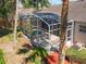 Aerial view of the screened lanai with a hot tub and outdoor seating area at 712 Timberwilde Ave, Winter Springs, FL 32708