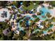 Aerial view of a resort featuring multiple pools, lush landscaping, and numerous lounge chairs and umbrellas at 7417 Marker Ave, Kissimmee, FL 34747