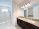 Granite-topped double sink bathroom with a shower and private toilet area, offering both functionality and style at 7417 Marker Ave, Kissimmee, FL 34747