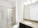 Bathroom featuring a glass-enclosed shower and a granite vanity at 7417 Marker Ave, Kissimmee, FL 34747