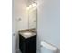 Bathroom featuring a toilet, granite vanity, mirror, and modern lighting at 7417 Marker Ave, Kissimmee, FL 34747