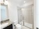 Bathroom featuring a walk-in shower, granite vanity, and modern fixtures at 7417 Marker Ave, Kissimmee, FL 34747