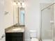 Bathroom featuring a granite vanity, mirror, modern lighting and walk-in shower at 7417 Marker Ave, Kissimmee, FL 34747