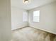 Cozy bedroom with neutral walls, carpeted floor, and natural light through two windows at 7417 Marker Ave, Kissimmee, FL 34747