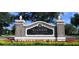 Reunion Resort & Club entrance sign with brick pillars, landscaping, and a palm tree emblem at 7417 Marker Ave, Kissimmee, FL 34747