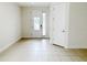 Bright foyer with tiled floors, a decorative glass front door, and white trim at 7417 Marker Ave, Kissimmee, FL 34747