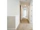 A bright carpeted hallway with neutral walls, offers easy access to various rooms, enhancing the home's layout at 7417 Marker Ave, Kissimmee, FL 34747