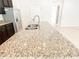 Close-up of the kitchen island with a granite countertop and stainless steel sink at 7417 Marker Ave, Kissimmee, FL 34747