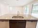 Close-up of granite island with stainless steel sink and dishwasher at 7417 Marker Ave, Kissimmee, FL 34747