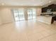 Open-concept kitchen and living area featuring tile flooring and sliding glass doors at 7417 Marker Ave, Kissimmee, FL 34747