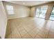 Living room features tile flooring, large windows and pool views at 7417 Marker Ave, Kissimmee, FL 34747