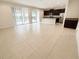 Open-concept kitchen and living area featuring tile flooring and sliding glass doors at 7417 Marker Ave, Kissimmee, FL 34747