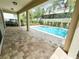 The backyard pool features a brick patio and is surrounded by lush greenery, offering a private retreat at 7417 Marker Ave, Kissimmee, FL 34747