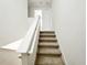 Carpeted stairway with white trim and railings leading to the upper level of the home at 7417 Marker Ave, Kissimmee, FL 34747