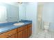 Bathroom featuring a long vanity with a large mirror and a walk-in bathtub at 7435 Redwing Rd, Groveland, FL 34736