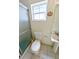 Bathroom with tiled floor, white toilet, sink and glass door shower at 7435 Redwing Rd, Groveland, FL 34736