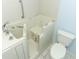 A walk-in bathtub with tile surround, chrome fixtures, and a mounted grab bar at 7435 Redwing Rd, Groveland, FL 34736