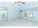 Bedroom with tile flooring, exterior access, and bright blue walls at 7435 Redwing Rd, Groveland, FL 34736