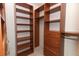 Spacious walk-in closet with custom wood shelving and drawers at 7435 Redwing Rd, Groveland, FL 34736