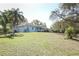 View of the exterior of the house featuring a well maintained lawn and mature trees at 7435 Redwing Rd, Groveland, FL 34736