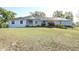 Charming light blue home with lush front lawn and well maintained landscaping at 7435 Redwing Rd, Groveland, FL 34736