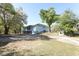 Exterior of light blue home with well-maintained lawn and driveway at 7435 Redwing Rd, Groveland, FL 34736