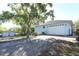 Exterior of light blue home with large garage at 7435 Redwing Rd, Groveland, FL 34736